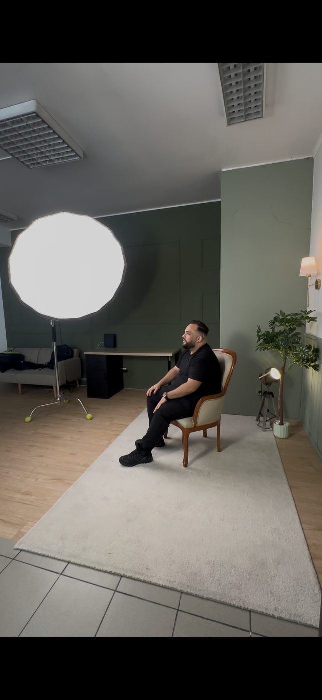 Iluminação de cena com softbox circular durante filmagem.